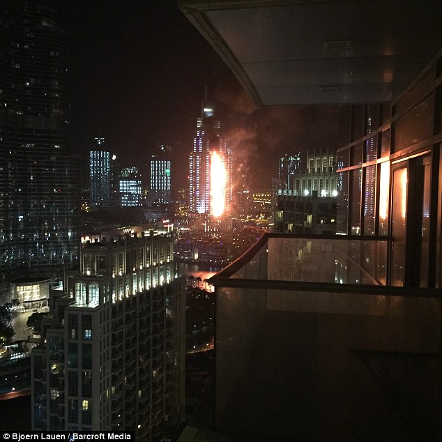Debris flies off Dubai building as massive fire rips through