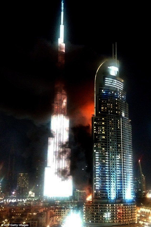 Debris flies off Dubai building as massive fire rips through