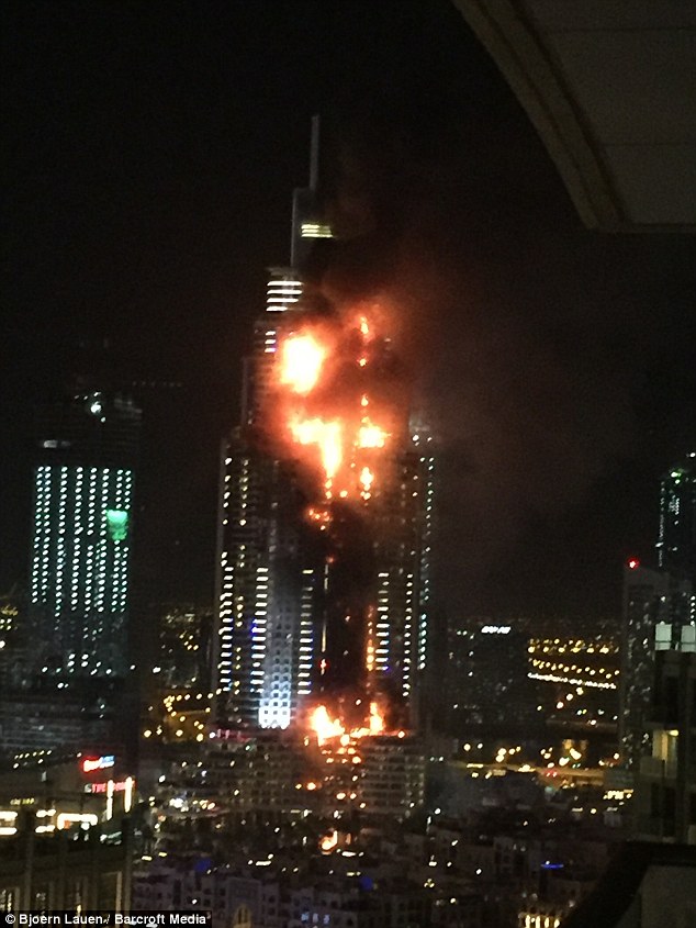 Debris flies off Dubai building as massive fire rips through