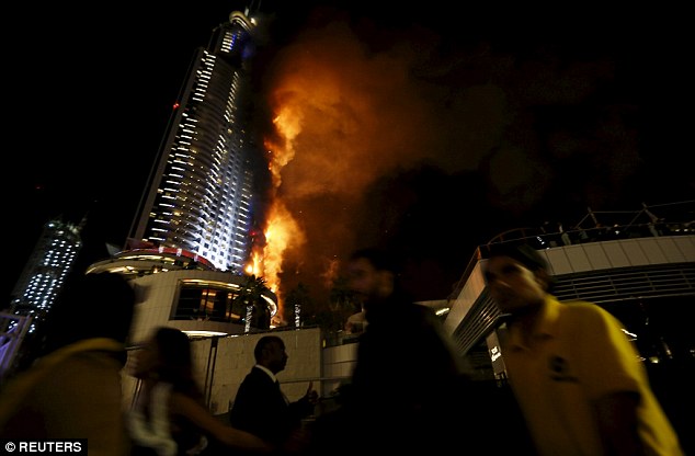 Debris flies off Dubai building as massive fire rips through