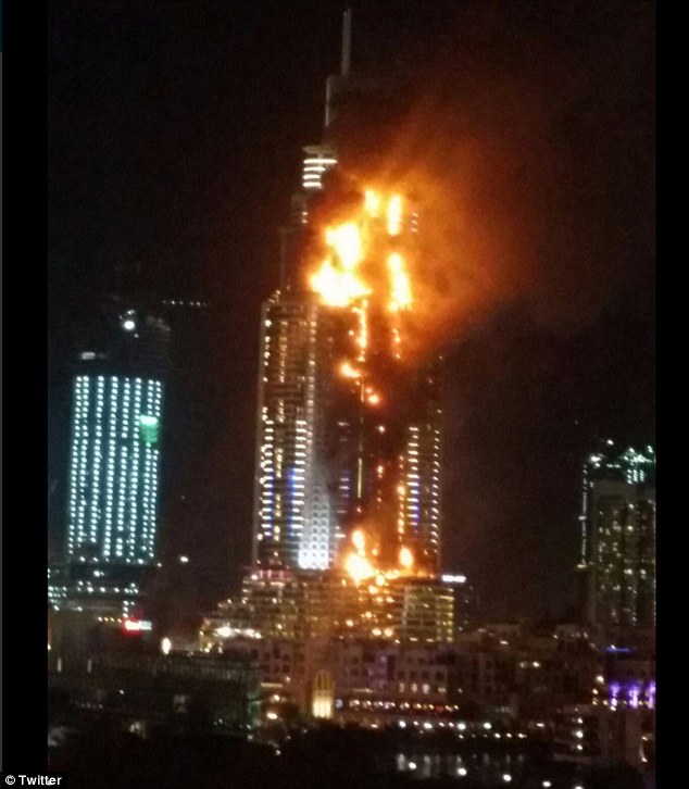 Debris flies off Dubai building as massive fire rips through