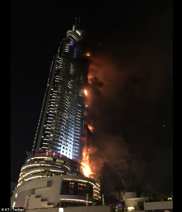 Debris flies off Dubai building as massive fire rips through