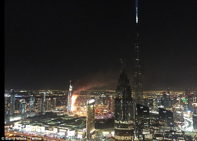 Debris flies off Dubai building as massive fire rips through