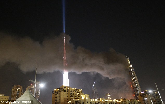 Debris flies off Dubai building as massive fire rips through