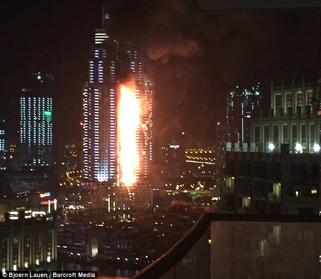 Debris flies off Dubai building as massive fire rips through