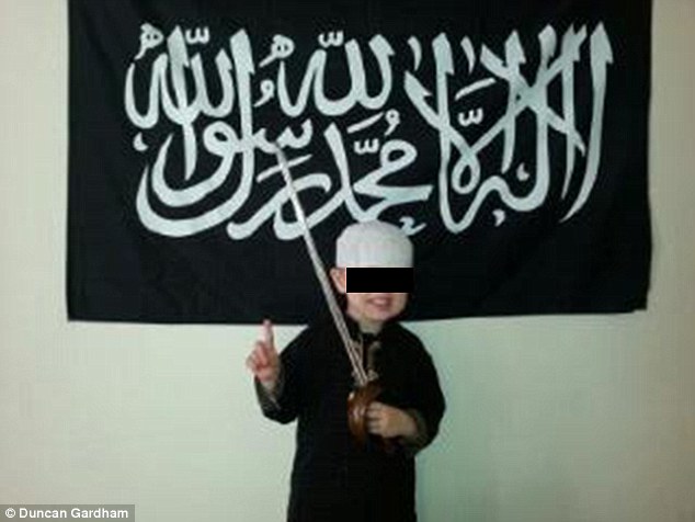 Age SIX and groomed for jihad in British suburbia: Shocking image of UK extremism, taken by little boy's Muslim convert father