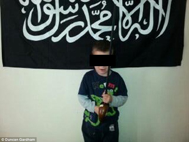Age SIX and groomed for jihad in British suburbia: Shocking image of UK extremism, taken by little boy's Muslim convert father