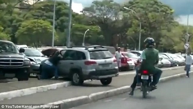 Shocking video- hows woman driver smashing motorcyclist ramming road parked cars kicked vehicle Shocking video- hows woman driver smashing motorcyclist ramming road parked cars kicked vehicle