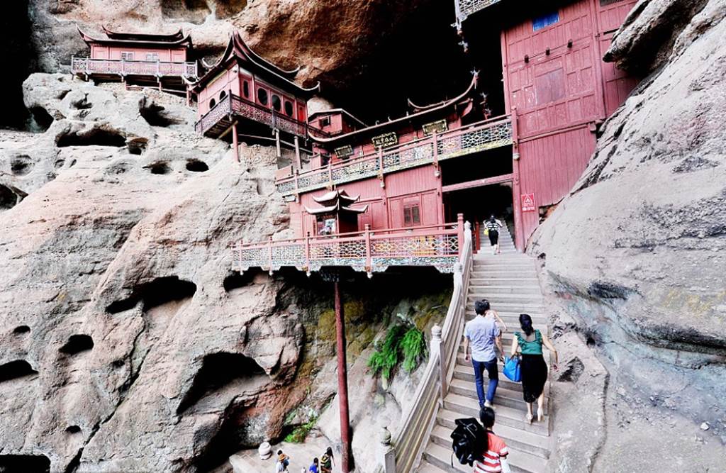 Temple of doom: Worshippers at Chinese holy site better watch their feet as it's carved into a 260ft cliff face