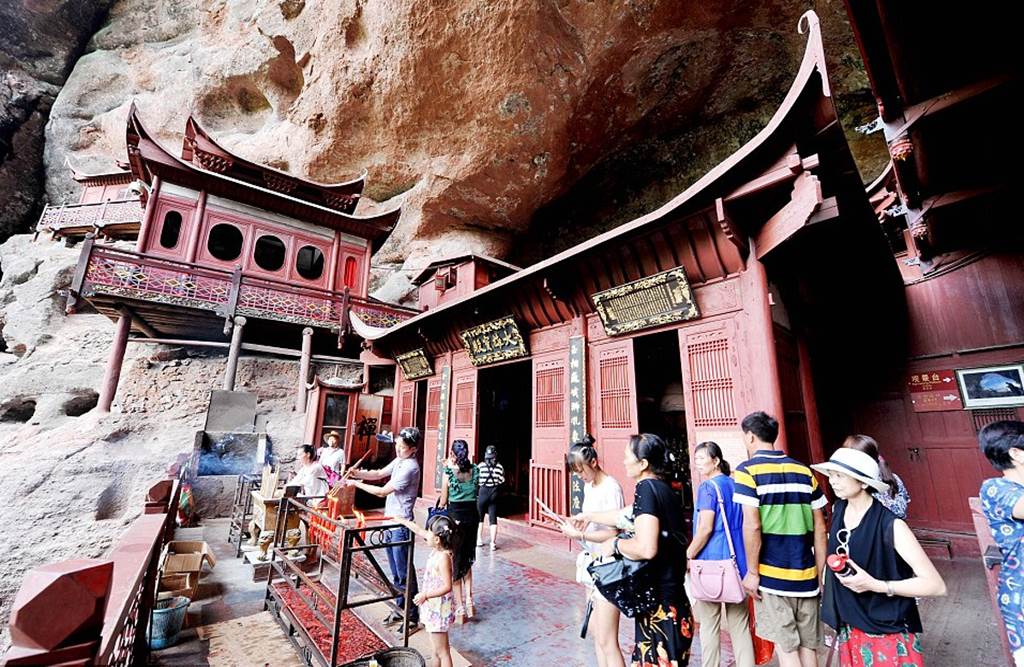 Temple of doom: Worshippers at Chinese holy site better watch their feet as it's carved into a 260ft cliff face