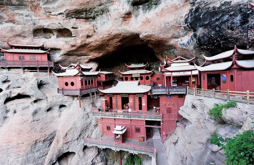 Temple of doom: Worshippers at Chinese holy site better watch their feet as it's carved into a 260ft cliff face