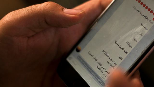 An activist looks at an ISIS marketplace on the encrypted app Telegram, advertising a 12-year-old Yazidi girl as a slave for the price of $12,500