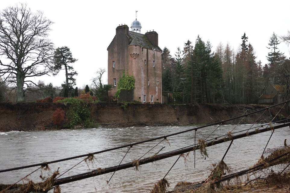 Calamity castle: Queen's neighbour flees 450-year-old home next to Balmoral which was left teetering on brink by rising flood waters as storms uncover 130-year-old ship wreck off Cornish coast