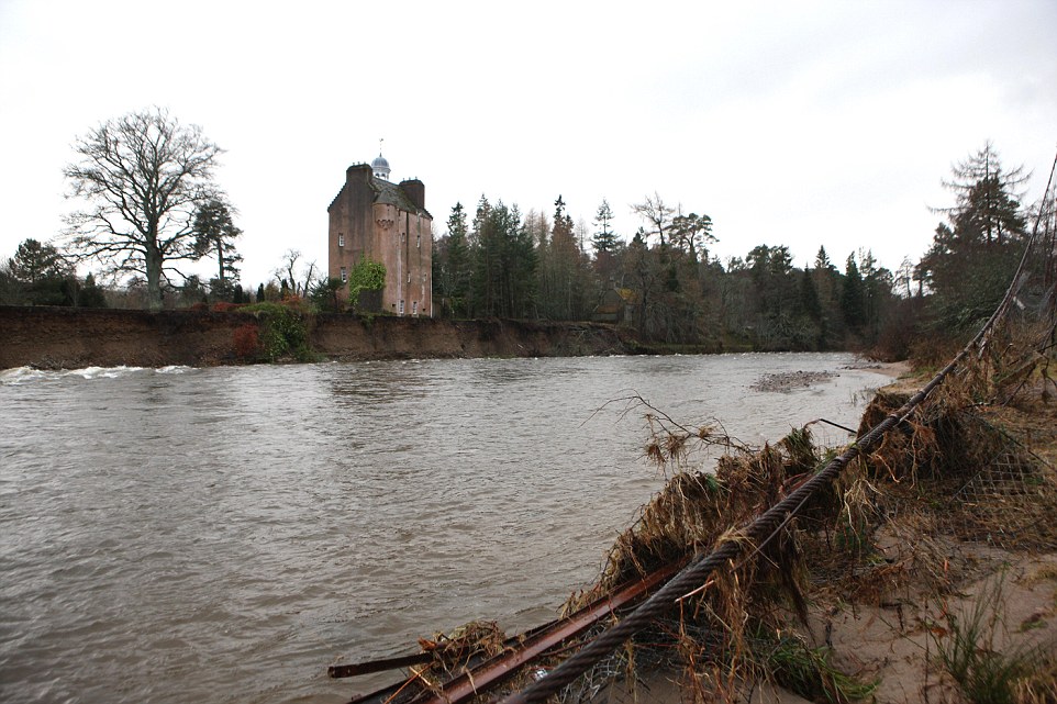 Calamity castle: Queen's neighbour flees 450-year-old home next to Balmoral which was left teetering on brink by rising flood waters as storms uncover 130-year-old ship wreck off Cornish coast